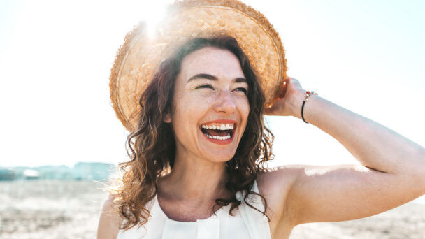 Happy Young Woman Smiling At The Beach