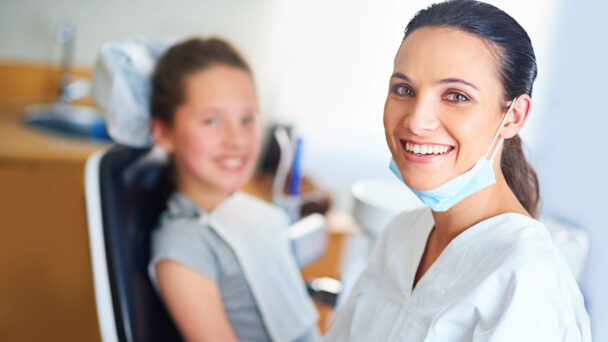 Portrait Of A Female Dentist And Child In A Dentist